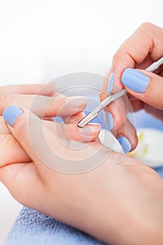 Manicurist Removing Cuticle From Nail photo