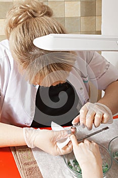 Manicurist removing cuticles photo