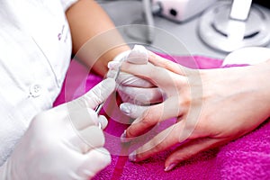 Manicurist taking care of her clients nails with style