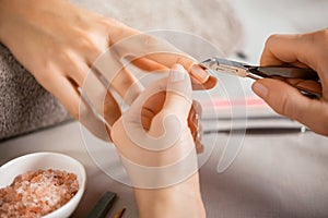 Manicurist using cuticle pusher