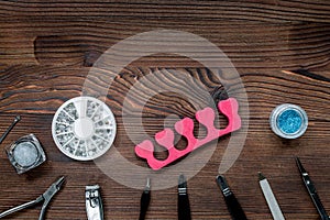 Manicurist work with manicure set for hands care wooden background top view mock up