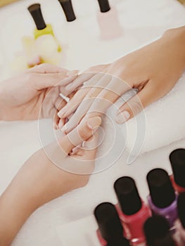 Manicurist Works with Clients in Beauty Salon.