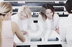 Manicurists doing nails to clients