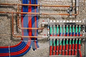 Manifold collector with pipes of underfloor heating system photo