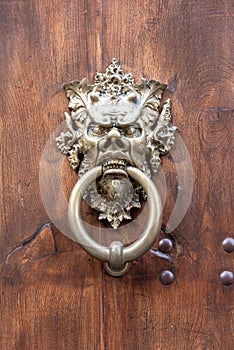 Door handle with metal mask depicting the devil photo