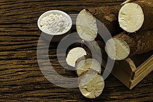 Manihot esculenta. Cassava, yuca, manioc, mandioca, Brazilian arrowroot. Tapioca on wooden background old. Selective focus