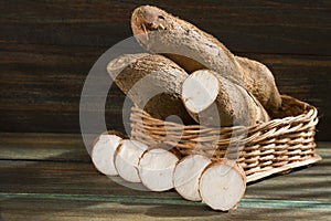 Manihot esculenta cassava, yuca, manioc, mandioca, Brazilian arrowroot and tapioca on wooden background. Selective focus