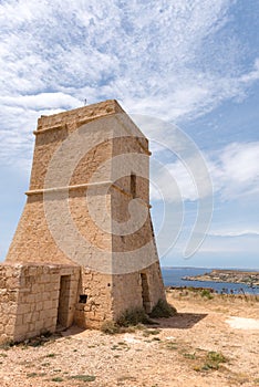 Panorama of Gnejna bay, the most beautiful beach in Malta at sunset with beautiful colorful sky and golden rocks