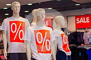 Manikens with sale sign in a shop