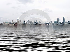 Manipulated conceptual image of the city of london with buildings flooded due to global warming and rising sea levels and gulls