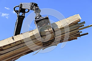 Manipulator for loading or unloading lumber and boards close-up