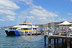 Manly Fast Ferry boat at Manly wharf ready to pick up passengers and depart to Sydney Cirqular Quay in the summer noon