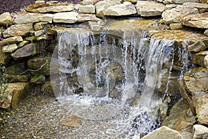 Manmade Waterfall Pours over Pebbles