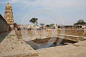 The Manmantha Tank and a series of shrines, Virupaksha Temple, Hampi, karnataka. Sacred Center. The Kangiri Gopura on the left sid