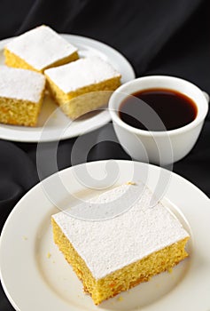 Manna cake with candied fruits and coffee on black background