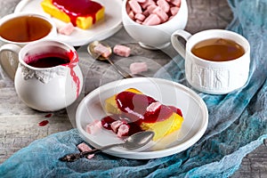 Manne cake with raspberry jam on a white plate. Tea party.