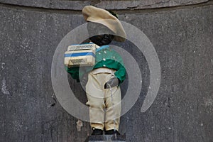 Brussels, Belgium - Closeup photo with a dressed statue of Manneken Pis seen close to the Grand Place