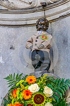 Manneken pis statue in costume in Brussels, Belgium