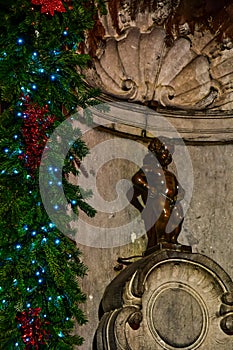 Manneken Pis (Little Man Pee), a bronze sculpture landmark near Grand Place, Brussels, Belgium,Christmas