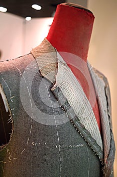 Mannequin with basted  jacket by a tailor