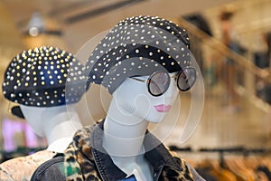 Mannequin in beret and glasses in a shop