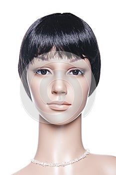 Mannequin with black hair posing on a white background in a high key setup