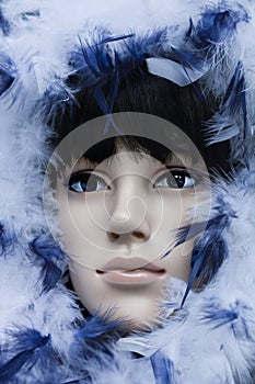 Mannequin with black hair wearing a hoodie with white and blue feathers