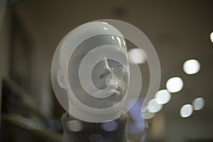 Mannequin in clothing store. Man's head. White figure