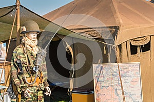 Mannequin dressed in military front of a tent