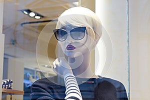 Mannequin face in black sunglasses and stylish clothing