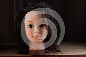 Mannequin of a female head. Doll head with hair. Female doll with green eyes