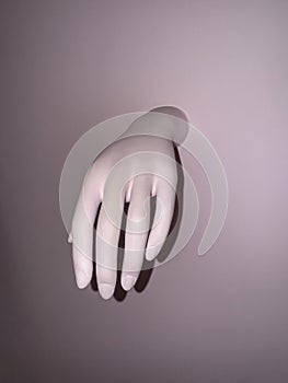 Mannequin hand on a pink background.