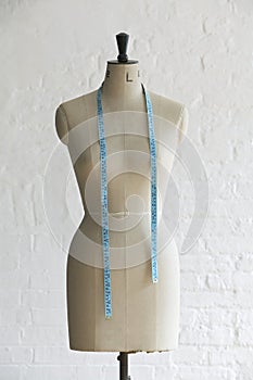 Mannequin with hanging measuring tape indoors