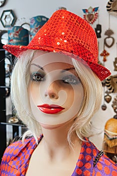 Mannequin in a hat in a shop window