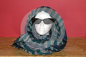 Mannequin head with sunglasses and scarf photo