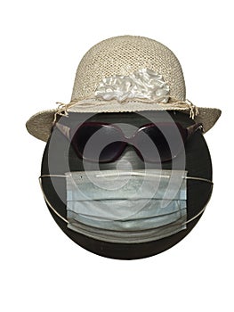 Mannequin head with sunglasses in a hat and in a protective mask isolated on a white background