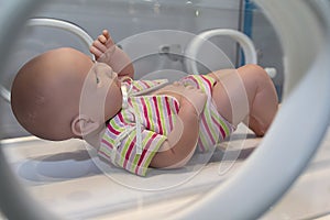 Mannequin infant in an incubator