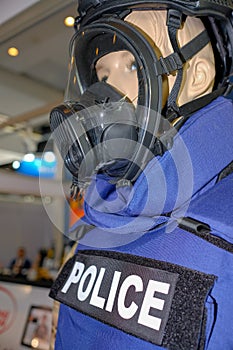Mannequin in Police uniform and wearing safety mask
