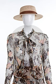 Mannequin portrait with abstract blouse and straw hat.