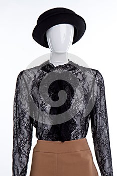 Mannequin portrait with black blouse and hat.