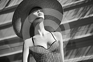 mannequin in a retrostyled swimsuit with a widebrim hat