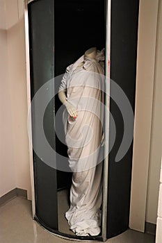 Mannequin in revolving darkroom door