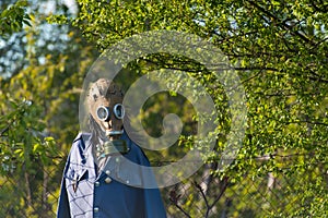 Mannequin, scarecrow with gas mask in nature photo