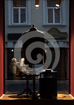 A mannequin silhouette in a small shop window.