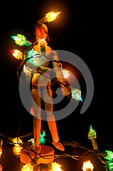 A mannequin tangled with christmas lights