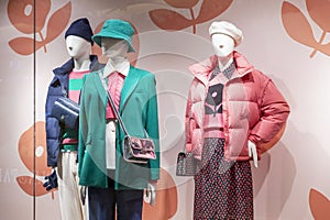 Mannequins in bright clothes in a store window. Fashion, style and beauty