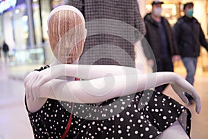 Mannequins in clothes on the background of shopping center stores