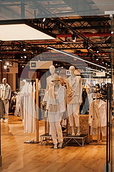 Mannequins in fashion shopfron. Boutique display window with mannequins in fashionable dresses