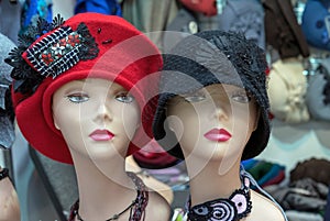 Mannequins with red and black female hats from the autumn collection