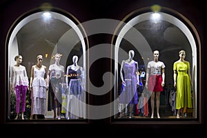 Mannequins at shopfront. Boutique window with dressed mannequins. Fashionable brand window display
